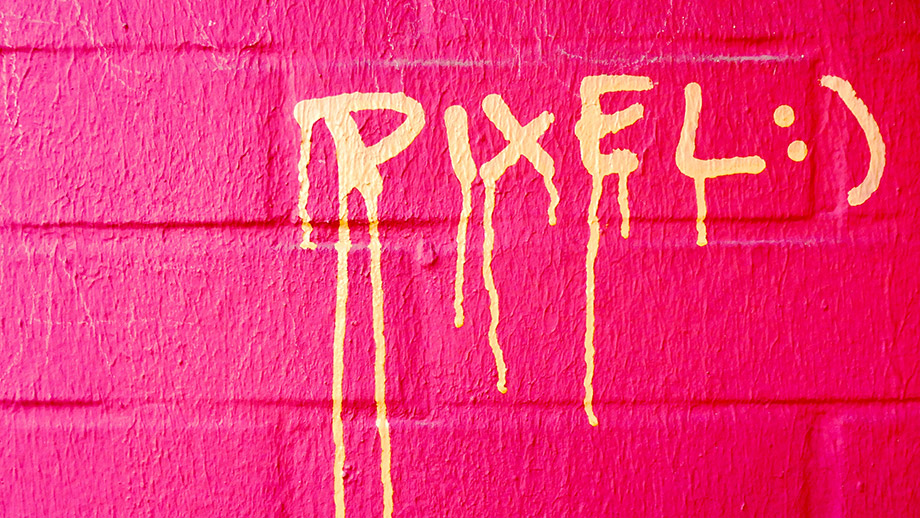 Pink wall with sprayed word "pixel" on it
